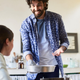 Man proudly gesturing to dish